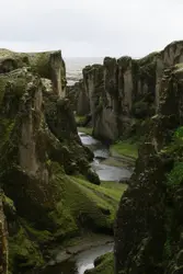 River With A Large Group Of Boulders And A Fence