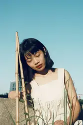 Woman Holding A Stick In A Field