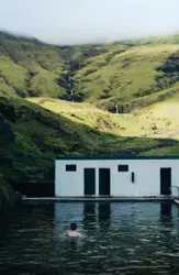 Boat Is Floating In The Water Near A Large Building