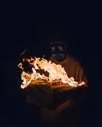 Person Is Lighting Candles On A Cake