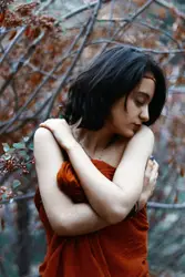 Woman Is Holding A Red Flower In Her Hand