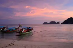 Small Boat On A Beach Near A Beach