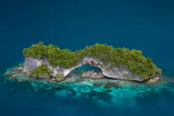 Large Rock Sitting On Top Of A Beach