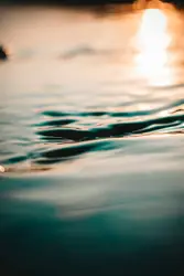 Blurry Image Of A Sunset With A Wave