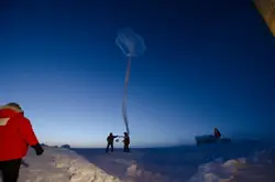 People Standing On Top Of A Snow Covered Field