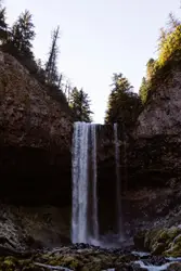 River With A Waterfall And A Rock Wall