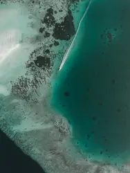 Large White Surfboard Floating On Top Of A Beach