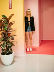 Woman Standing In Front Of A Wall With A Red Wall