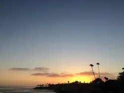 Sunset With A Beach And A Lighthouse
