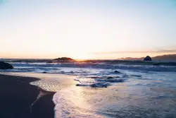 Beach With A Few Boats On It