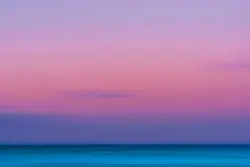 Calm body of water with orange sky