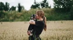Woman kissing dog