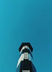 White and blue lighthouse in low angle photography duri