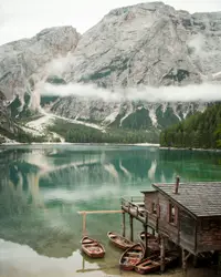 Boats under wooden house near mountain