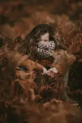 Woman hiding on grass field