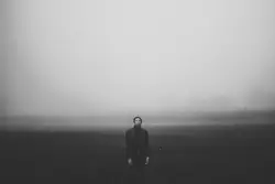 Grayscale photo of man wearing suit jacket