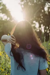Woman in white t shirt walking on flower field during d