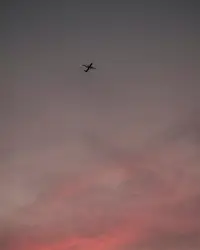 Airplane on mid air under cloudy sky
