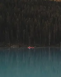 The glassy reflection of Lake Louise's water creates an