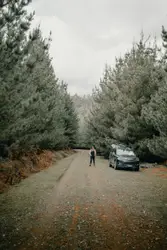 Person standing near black car