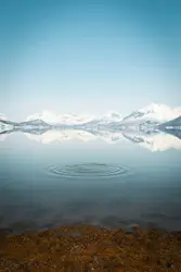 A large body of water with mountains in the background