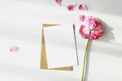 White bond paper beside pink petaled flower