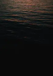 The sun is setting over a body of water