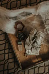 Pair of pumps beside jewelry box on wooden tray