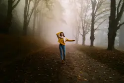 Woman walking near trees during day