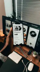 Person holding white and black smartphone