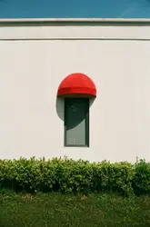 Glass paneled window with red canopy