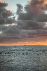 Body of water under cloudy sky during daytime