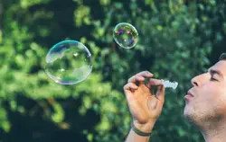 A photo of my friend blowing bubbles in Tilgate Park.