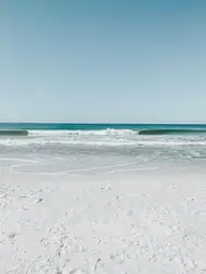 White sand beach under clear blue sky