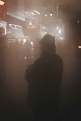 A man standing in the middle of a street at night