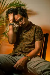 Man sitting on brown chair