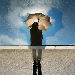 Person standing on gray surface while holding umbrella