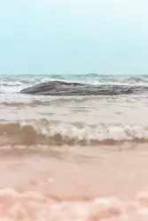 A large rock sticking out of the ocean