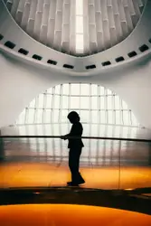 Man Standing On A Ledge With A Large Clock