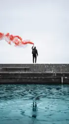 Man Walking On A Ledge Near A Body Of Water