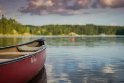 Red canoe boat on body of water