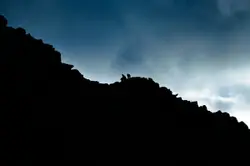 Low angle of person on rock cliff