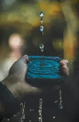 Person holding smartphone with water drops
