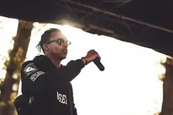 Man holding black microphone performing on stage