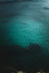 Large Blue And White Boat Floating On Top Of A Blue Ocean