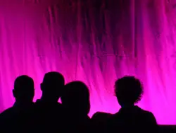 Silhouette of people standing on stage
