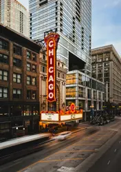 The chicago theatre shines brightly at dusk.