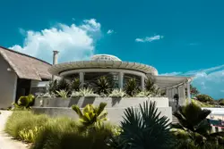 White concrete building with green plants during daytim