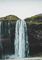 Group of people standing near waterfalls