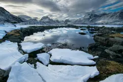 Bottom of mountain snow pond